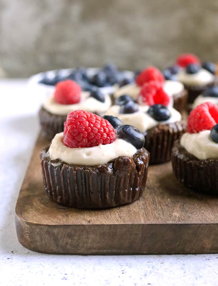 These Paleo Pudding Filled Brownie Bites are such a fun dessert. An easy brownie is made in a muffin pan and filled with dairy free pudding and topped with berries. They're dairy free, gluten free, low FODMAP, and naturally sweetened.