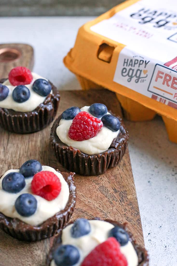 These Paleo Pudding Filled Brownie Bites are such a fun dessert. An easy brownie is made in a muffin pan and filled with dairy free pudding and topped with berries. They're dairy free, gluten free, low FODMAP, and naturally sweetened.