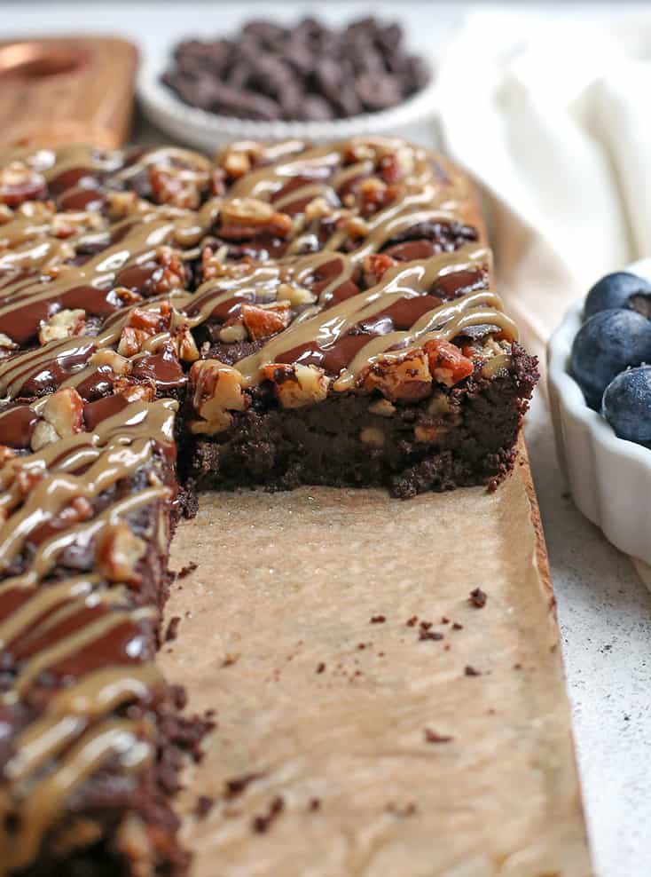 These Paleo Turtle Brownies have a rich, chocolate base, layered with caramel, topped with pecans and chocolate chips and drizzled with more caramel. A decadent treat that is gluten free, dairy free, and low FODMAP.