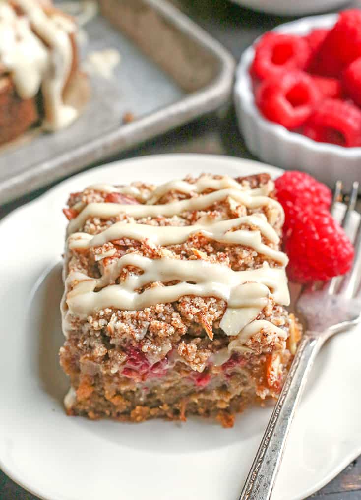 This Paleo Raspberry Cheesecake Coffee Cake tender, moist, and full of fresh raspberries. Topped with a dairy free cheesecake drizzle makes it even more amazing! It's gluten free, dairy free and naturally sweetened.