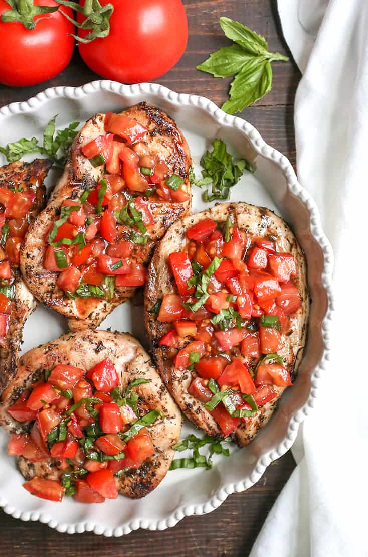 This Paleo Whole30 Bruschetta Chicken is easy and tastes amazing! A simple marinade for the chicken topped with a tomato balsamic mixture that is so flavorful. It's gluten free, dairy free, low carb and low FODMAP.