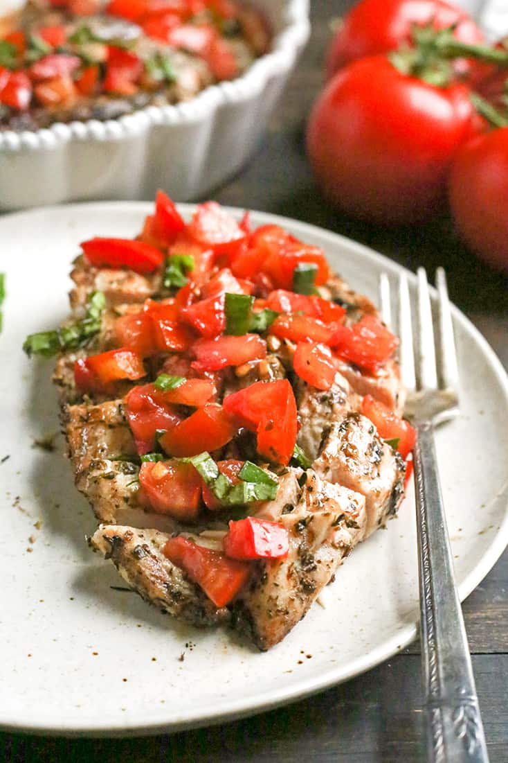 This Paleo Whole30 Bruschetta Chicken is easy and tastes amazing! A simple marinade for the chicken topped with a tomato balsamic mixture that is so flavorful. It's gluten free, dairy free, low carb and low FODMAP.