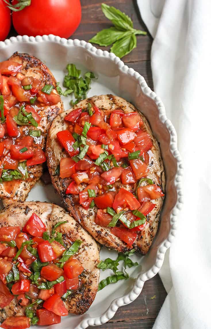 This Paleo Whole30 Bruschetta Chicken is easy and tastes amazing! A simple marinade for the chicken topped with a tomato balsamic mixture that is so flavorful. It's gluten free, dairy free, low carb and low FODMAP.