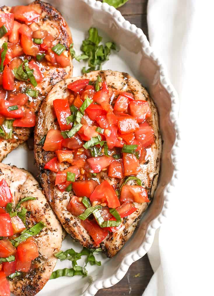 This Paleo Whole30 Bruschetta Chicken is easy and tastes amazing! A simple marinade for the chicken topped with a tomato balsamic mixture that is so flavorful. It's gluten free, dairy free, low carb and low FODMAP.