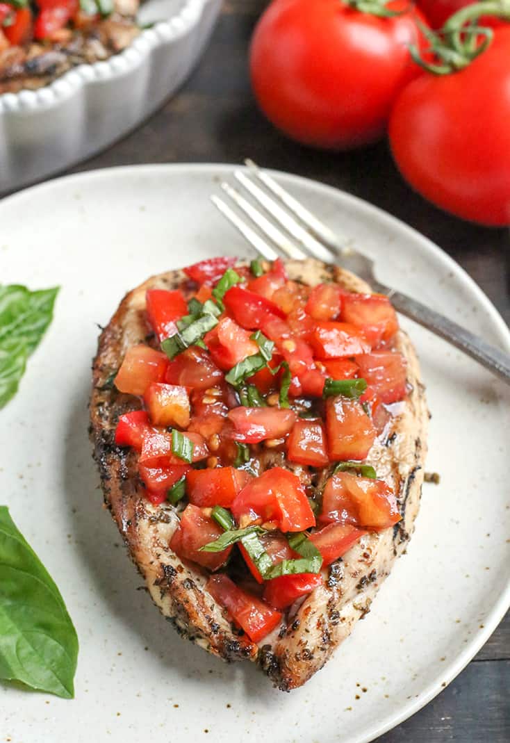 This Paleo Whole30 Bruschetta Chicken is easy and tastes amazing! A simple marinade for the chicken topped with a tomato balsamic mixture that is so flavorful. It's gluten free, dairy free, low carb and low FODMAP.