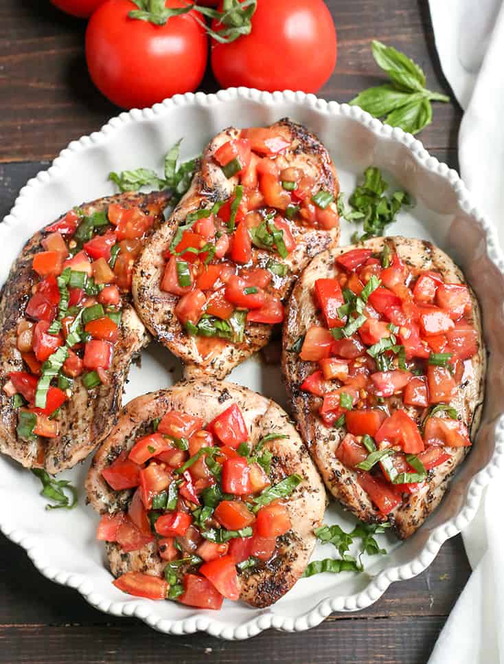 This Paleo Whole30 Bruschetta Chicken is easy and tastes amazing! A simple marinade for the chicken topped with a tomato balsamic mixture that is so flavorful. It's gluten free, dairy free, low carb and low FODMAP.