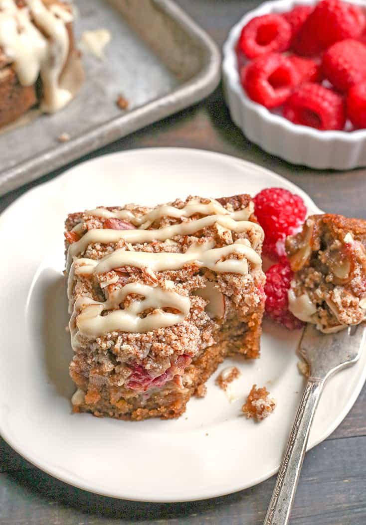 This Paleo Raspberry Cheesecake Coffee Cake tender, moist, and full of fresh raspberries. Topped with a dairy free cheesecake drizzle makes it even more amazing! It's gluten free, dairy free and naturally sweetened.