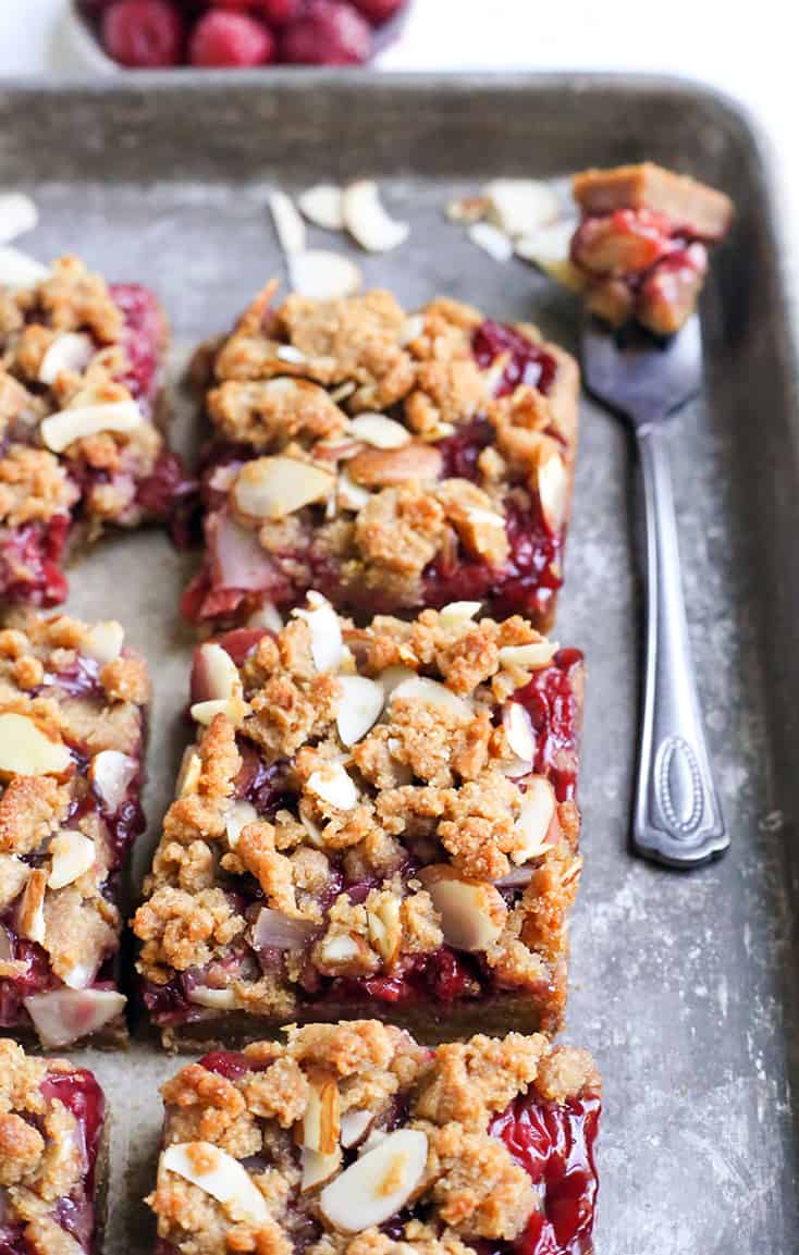 These Paleo Cherry Pie Crumb Bars are so simple and delicious! A thick shortbread crust, fresh fruit filling and irresistible crumb topping. These layered bars are vegan, gluten free, dairy free, and naturally sweetened.