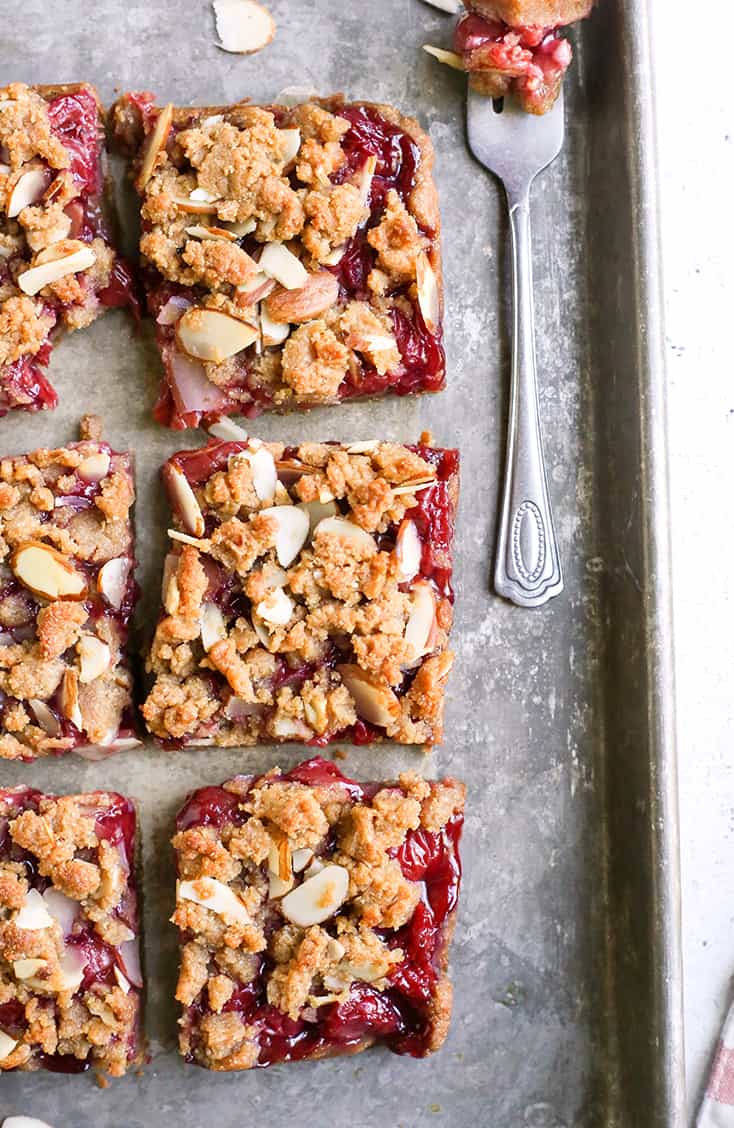 These Paleo Cherry Pie Crumb Bars are so simple and delicious! A thick shortbread crust, fresh fruit filling and irresistible crumb topping. These layered bars are vegan, gluten free, dairy free, and naturally sweetened.