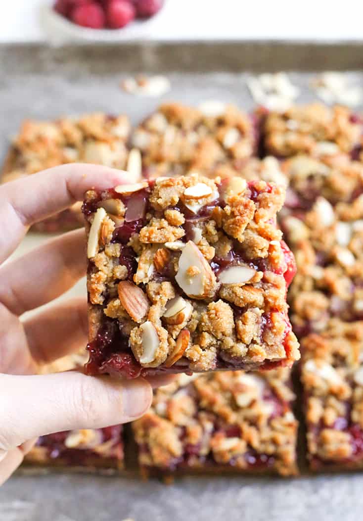 These Paleo Cherry Pie Crumb Bars are so simple and delicious! A thick shortbread crust, fresh fruit filling and irresistible crumb topping. These layered bars are vegan, gluten free, dairy free, and naturally sweetened.