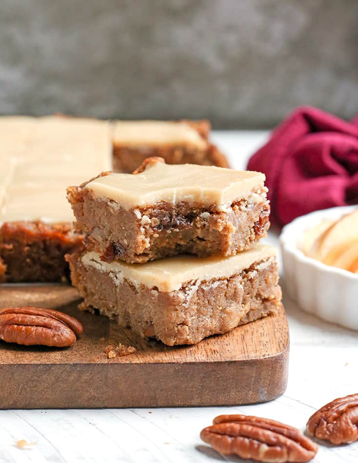 These Paleo Vegan Apple Cinnamon Bars are so delicious and simple to make. A moist cookie base with a sweet frosting. They are gluten free, dairy free, egg free, and naturally sweetened.