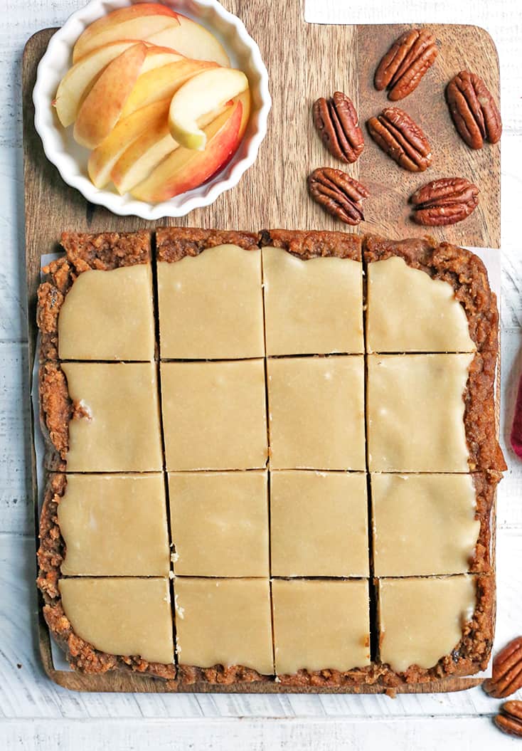 These Paleo Vegan Apple Cinnamon Bars are so delicious and simple to make. A moist cookie base with a sweet frosting. They are gluten free, dairy free, egg free, and naturally sweetened.