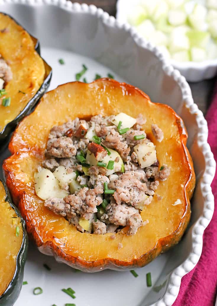 This Paleo Whole30 Sausage Stuffed Acorn Squash is filling, flavorful, and healthy. A homemade sausage, apples, and pecans stuffed into a tender acorn squash. Gluten free, dairy free, and can be made low FODMAP.