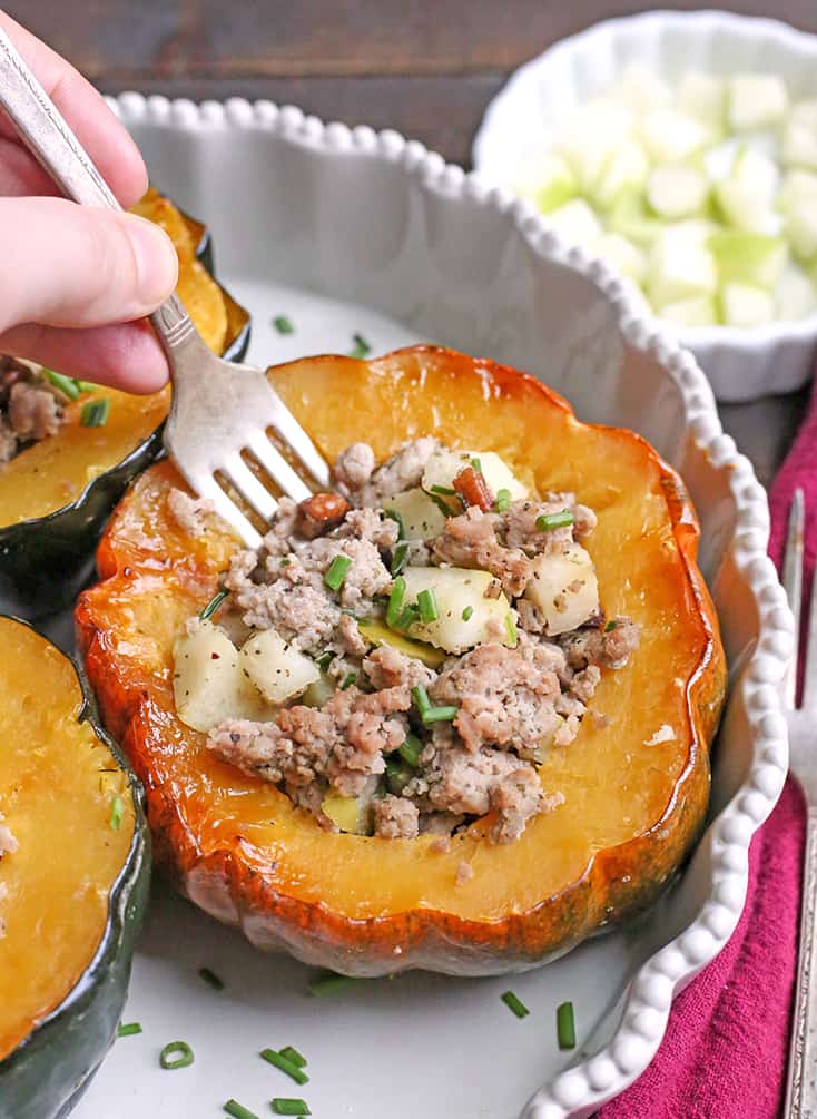 This Paleo Whole30 Sausage Stuffed Acorn Squash is filling, flavorful, and healthy. A homemade sausage, apples, and pecans stuffed into a tender acorn squash. Gluten free, dairy free, and can be made low FODMAP.