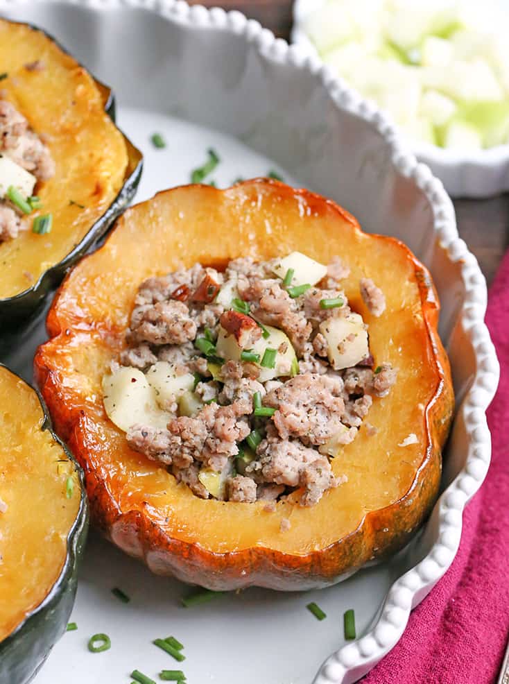 This Paleo Whole30 Sausage Stuffed Acorn Squash is filling, flavorful, and healthy. A homemade sausage, apples, and pecans stuffed into a tender acorn squash. Gluten free, dairy free, and can be made low FODMAP.