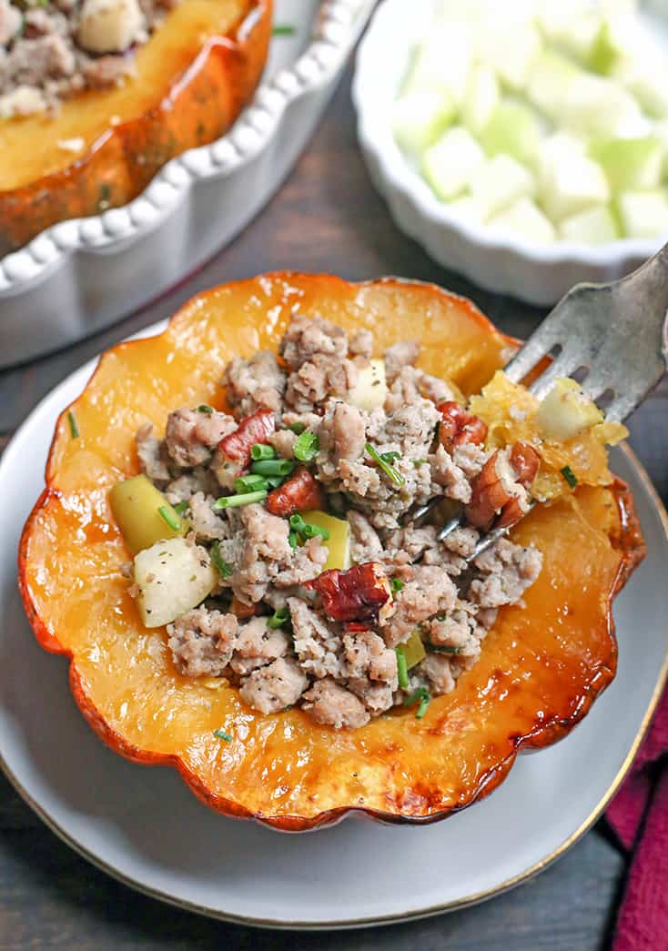 This Paleo Whole30 Sausage Stuffed Acorn Squash is filling, flavorful, and healthy. A homemade sausage, apples, and pecans stuffed into a tender acorn squash. Gluten free, dairy free, and can be made low FODMAP.