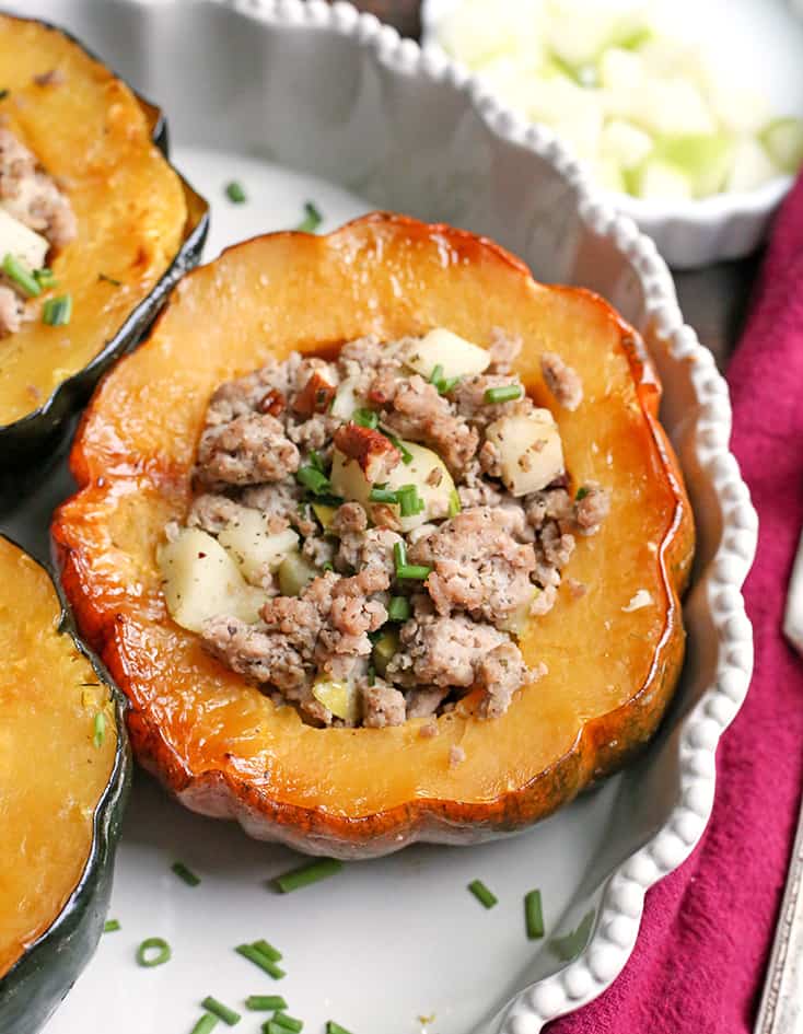 This Paleo Whole30 Sausage Stuffed Acorn Squash is filling, flavorful, and healthy. A homemade sausage, apples, and pecans stuffed into a tender acorn squash. Gluten free, dairy free, and can be made low FODMAP.