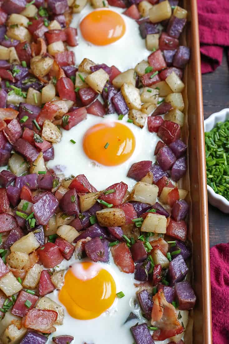 This Paleo Whole30 Sheet Pan Hash and Eggs is so simple to make and delicious! Crispy potatoes, bacon, and perfectly cooked eggs. It's gluten free, dairy free, and low FODMAP.