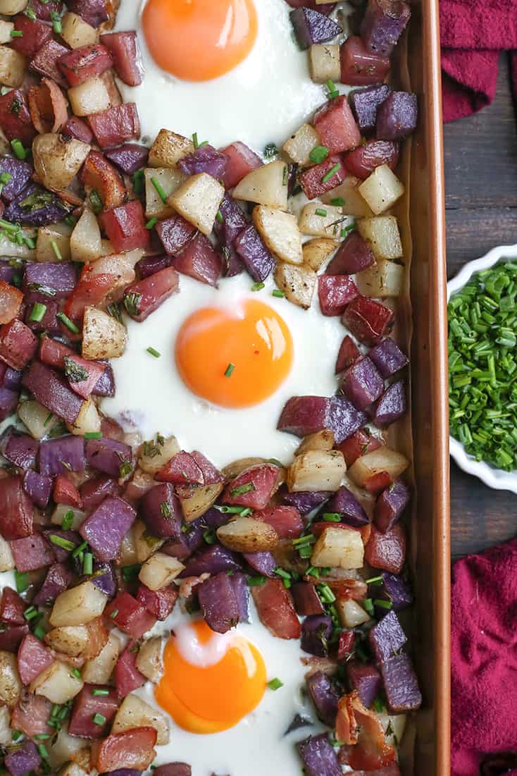 This Paleo Whole30 Sheet Pan Hash and Eggs is so simple to make and delicious! Crispy potatoes, bacon, and perfectly cooked eggs. It's gluten free, dairy free, and low FODMAP.
