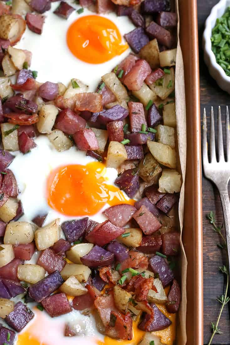 This Paleo Whole30 Sheet Pan Hash and Eggs is so simple to make and delicious! Crispy potatoes, bacon, and perfectly cooked eggs. It's gluten free, dairy free, and low FODMAP.