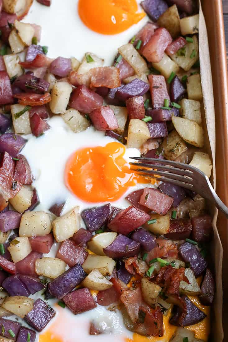 This Paleo Whole30 Sheet Pan Hash and Eggs is so simple to make and delicious! Crispy potatoes, bacon, and perfectly cooked eggs. It's gluten free, dairy free, and low FODMAP.