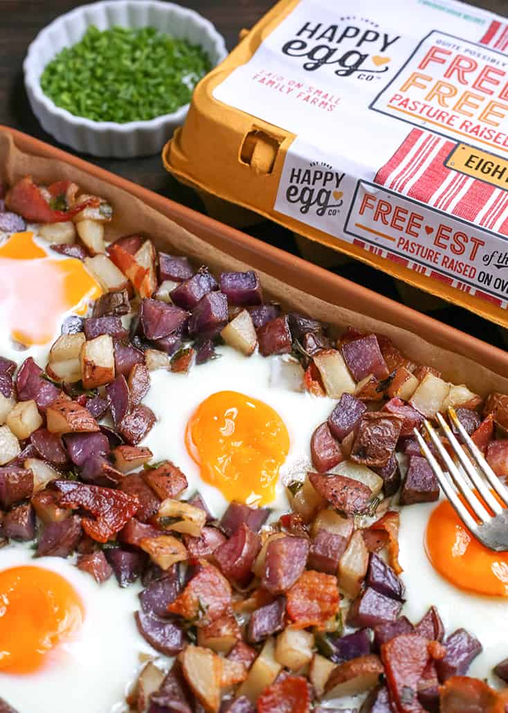 This Paleo Whole30 Sheet Pan Hash and Eggs is so simple to make and delicious! Crispy potatoes, bacon, and perfectly cooked eggs. It's gluten free, dairy free, and low FODMAP.