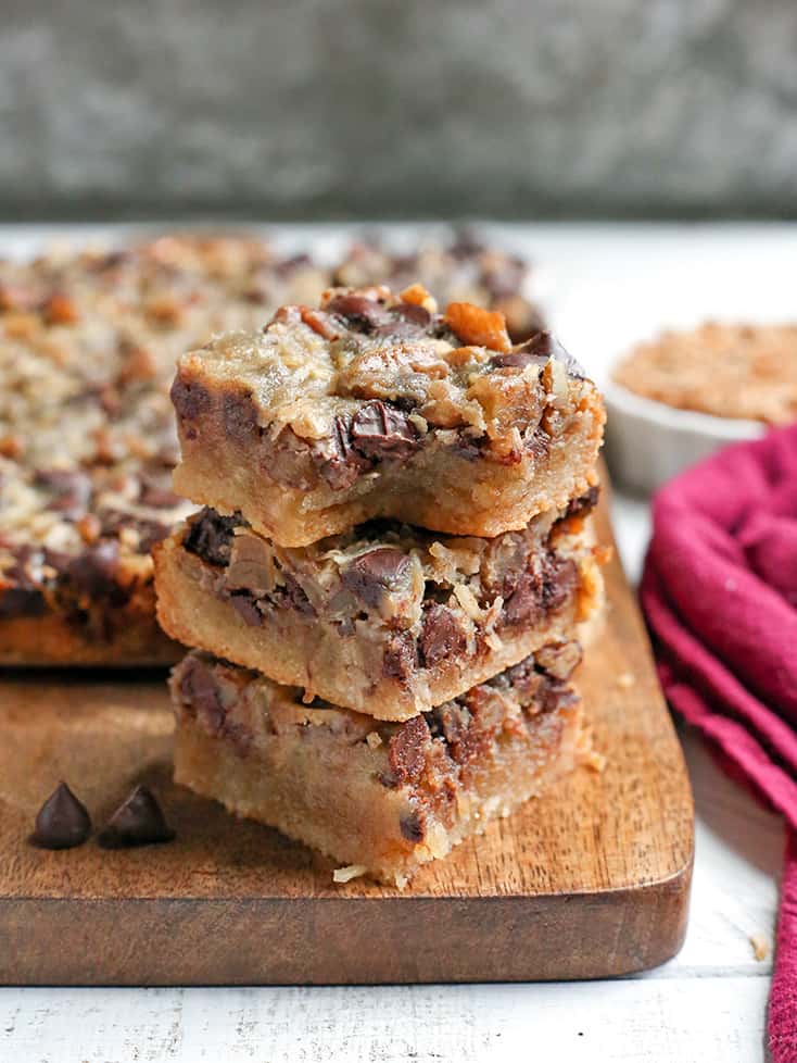 These Paleo Magic Cookie Bars are a healthier version of the classic dessert. A shortbread crust topped with shredded coconut, chopped pecans, chocolate chips and a homemade sweetened condensed milk poured on top. They are gluten free, dairy free, naturally sweetened with a vegan option.