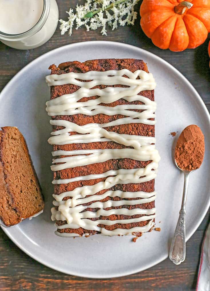 This Paleo Pumpkin Cinnamon Roll Bread is so easy to make and tastes incredible! Tender cake with a sweet pumpkin spice swirl and drizzled with a thick glaze. Gluten free, dairy free, and naturally sweetened.