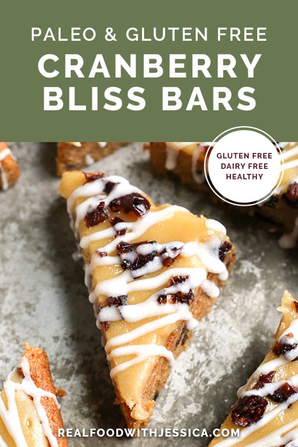 These Paleo Cranberry Bliss Bars have a thick cookie layer studded with chewy cranberries, topped with creamy dairy free cheesecake and a white drizzle. They are gluten free, dairy free, and naturally sweetened.