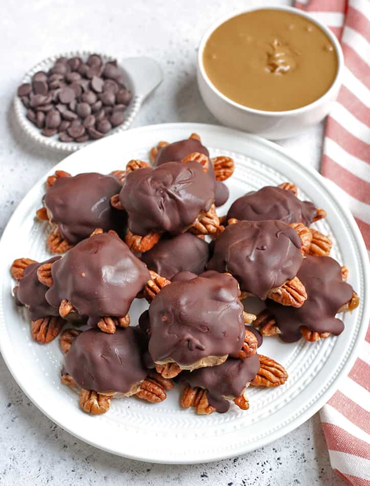 These Paleo Vegan Pecan Turtles are simple to make, no-bake, and so tasty. A healthy version of the classic candy. Sweet caramel on top of crunchy pecans and topped with chocolate. They are gluten free, dairy free, low FODMAP and naturally sweetened. 