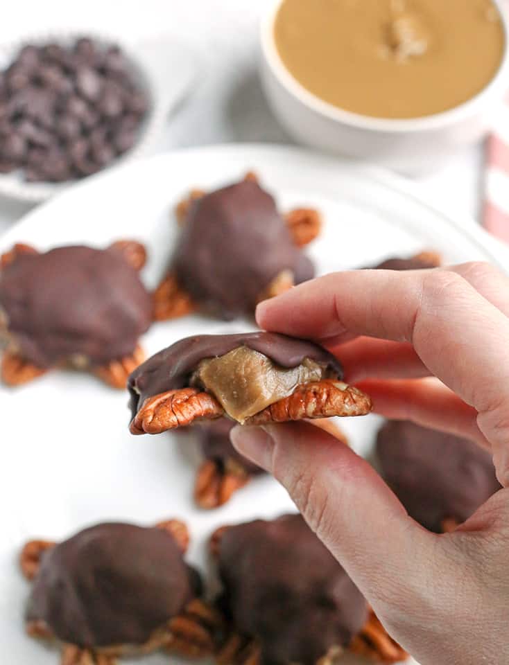 These Paleo Vegan Pecan Turtles are simple to make, no-bake, and so tasty. A healthy version of the classic candy. Sweet caramel on top of crunchy pecans and topped with chocolate. They are gluten free, dairy free, low FODMAP and naturally sweetened. 