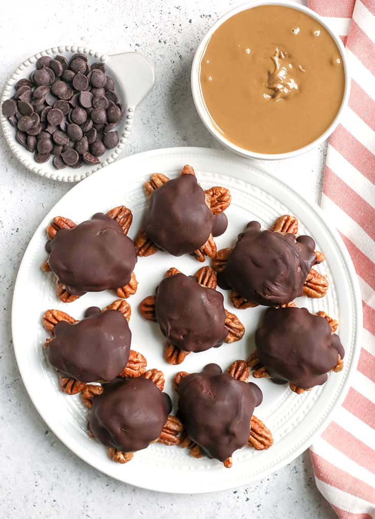 These Paleo Vegan Pecan Turtles are simple to make, no-bake, and so tasty. A healthy version of the classic candy. Sweet caramel on top of crunchy pecans and topped with chocolate. They are gluten free, dairy free, low FODMAP and naturally sweetened. 