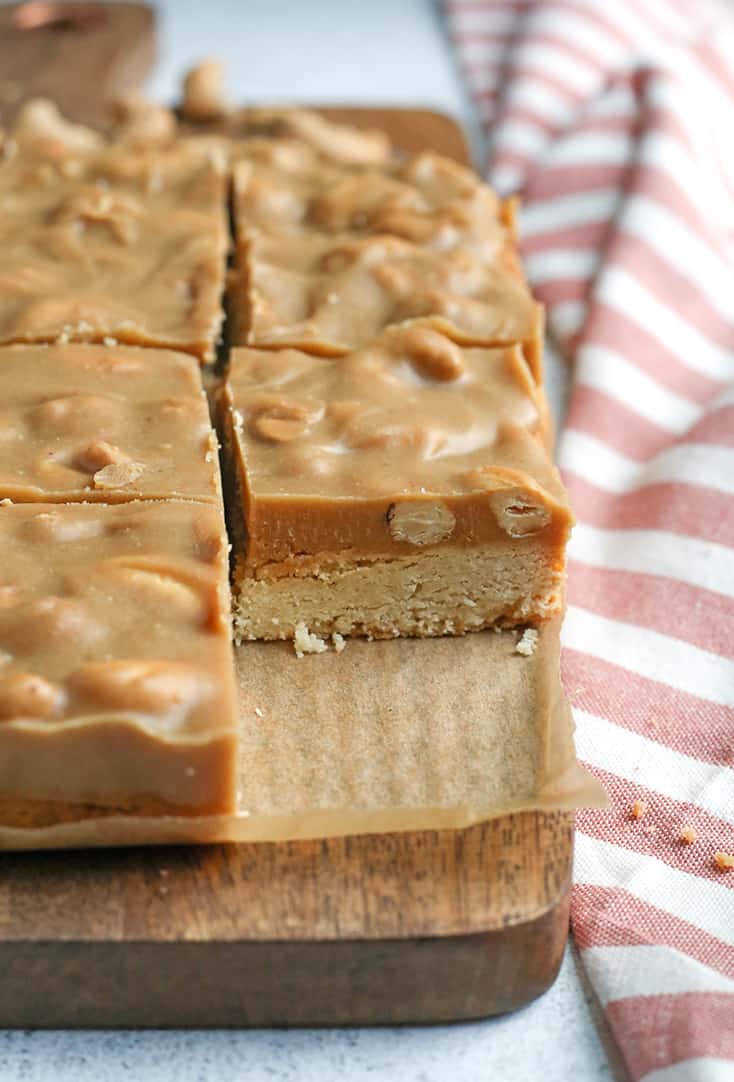 These Paleo Caramel Cashew Bars are easy to make, rich, and so good! A shortbread layer topped with a fudge-like layer that is sweet and packed with buttery cashews. They are gluten free, dairy free, vegan, and naturally sweetened.