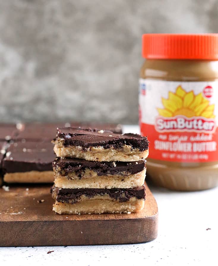 These Paleo Nut Free Tagalong Bars are simple to make and so delicious. A shortbread crust, sweet SunButter layer, and topped with chocolate. They are vegan, gluten free, dairy free, and naturally sweetened.