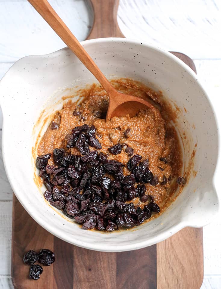 the dough for the paleo cherry chocolate chip bars with the dried cherries on top 