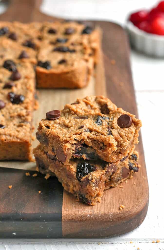 paleo cherry chocolate chips bars stacked on each other with a bite taken out