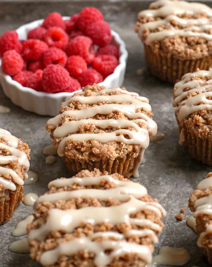 paleo coffee cake muffins on a tray with raspberries 