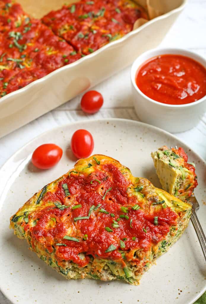 paleo sausage breakfast casserole on a plate with a bite taken out