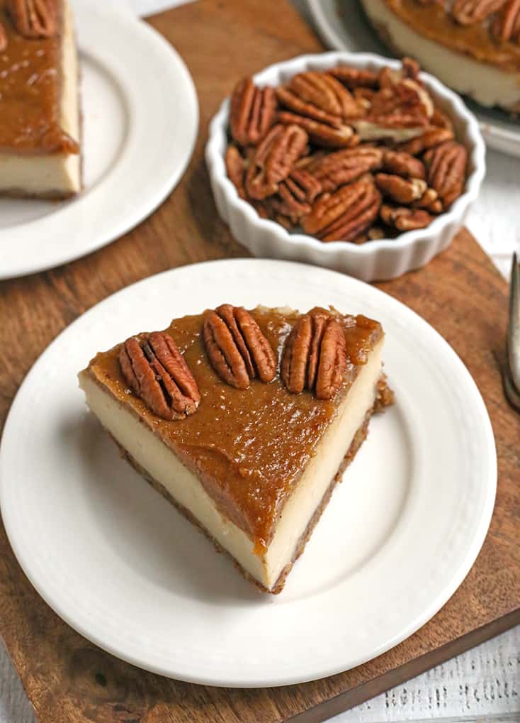 a piece of paleo vegan caramel pecan cheesecake on a plate