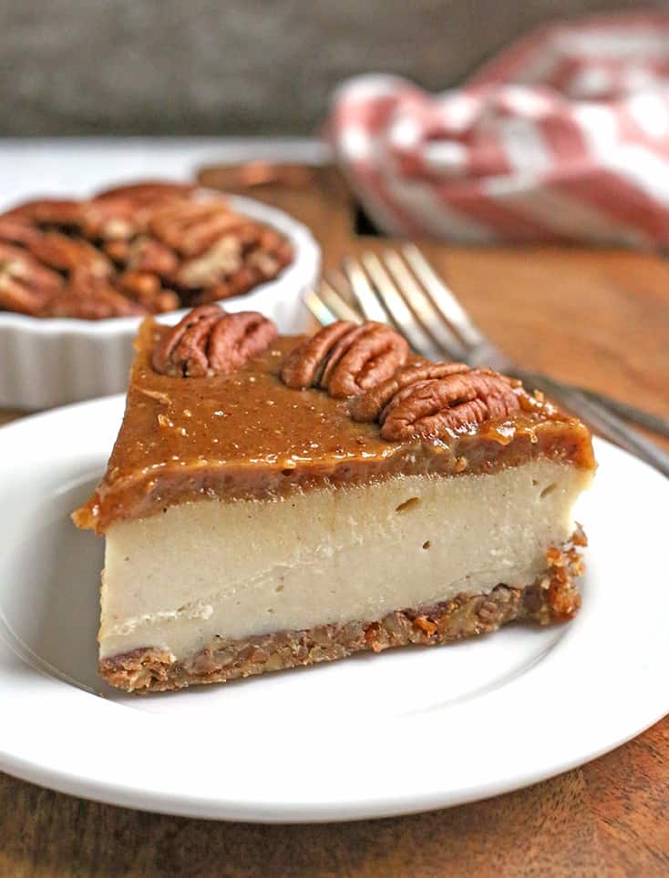 a slice of paleo vegan caramel pecan cheesecake  