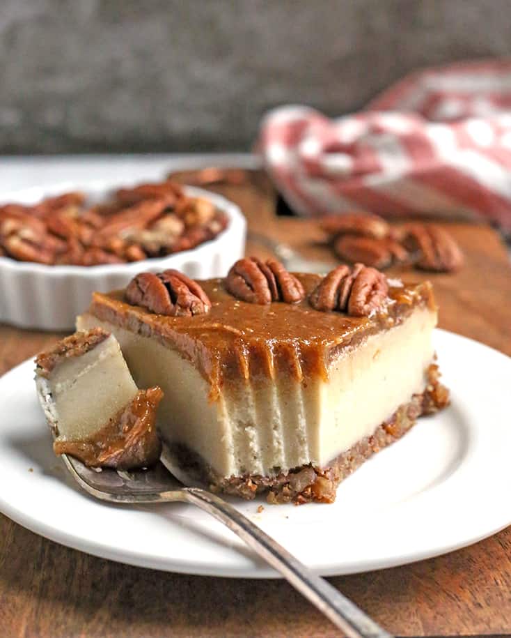 paleo vegan caramel pecan cheesecake with bite taken out