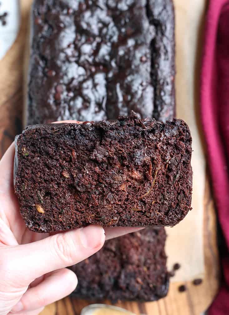 hand holding a slice of paleo vegan chocolate zucchini bread 