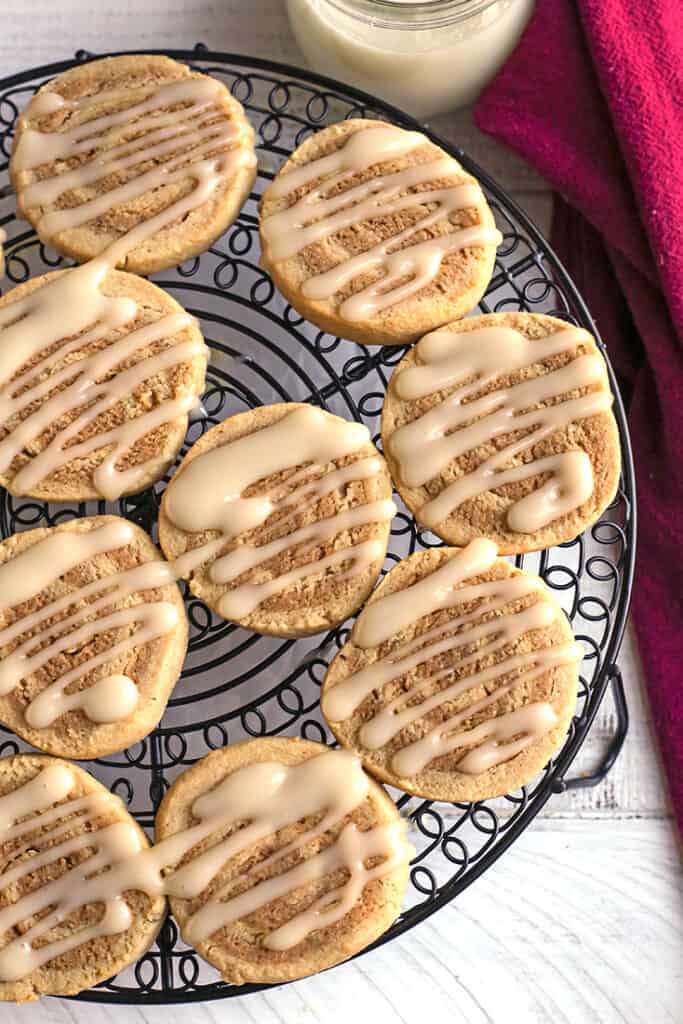 paleo cinnamon roll cookies with glaze on them 