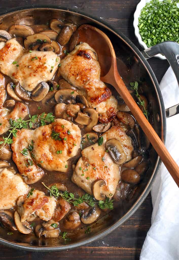 paleo creamy mushroom chicken with a spoon in the pan