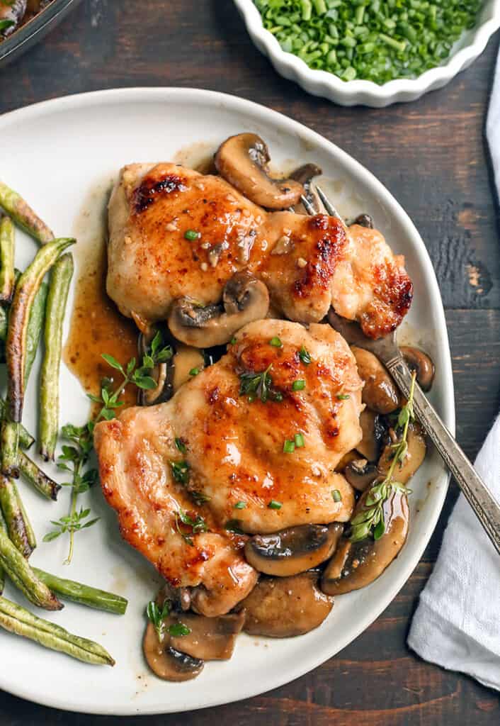 creamy paleo mushroom chicken on a plate. Close up with a fork