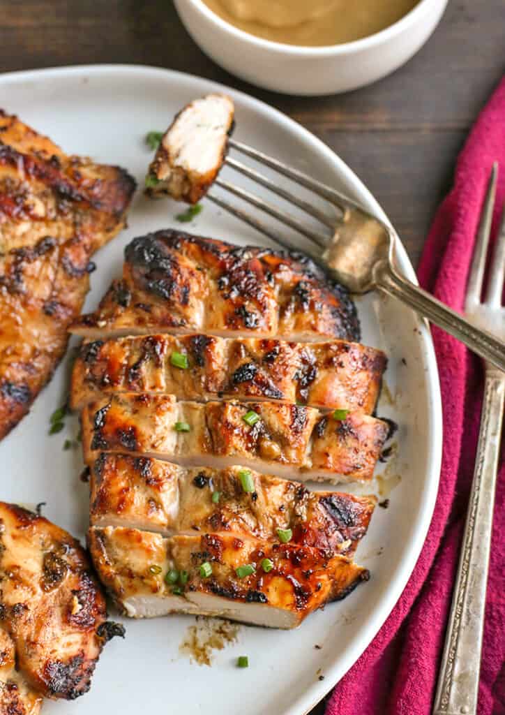 paleo grilled honey mustard chicken, cut on a plate 