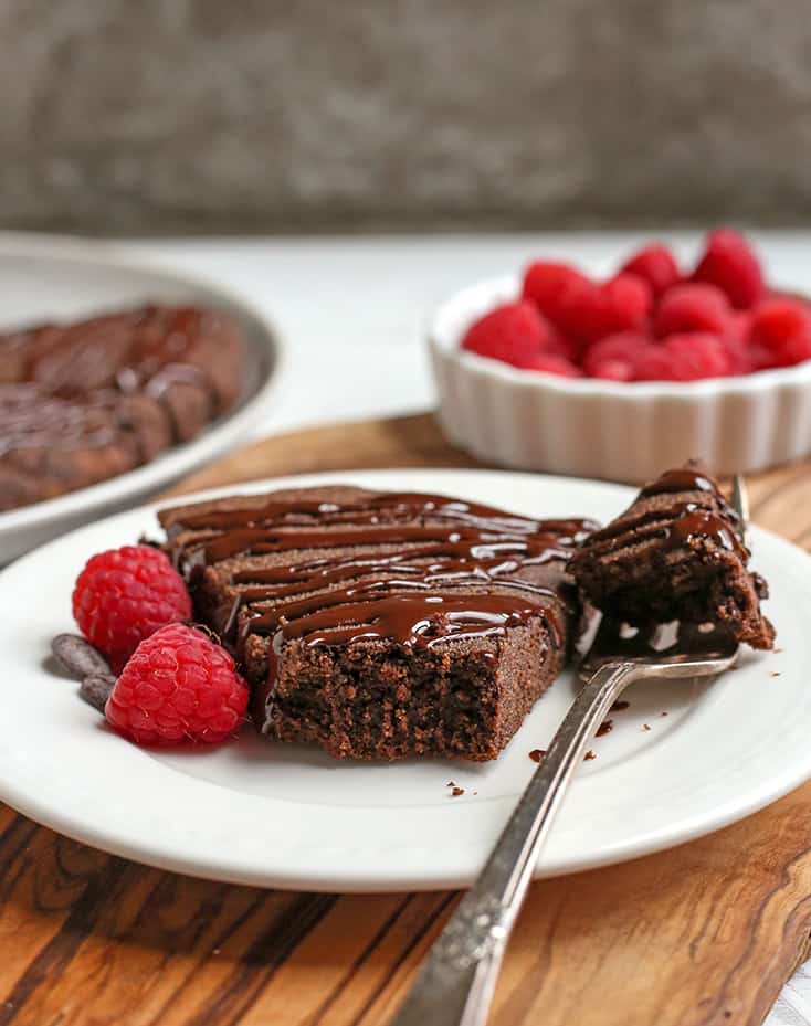 a paleo triple chocolate scone on a plate with a bite taken