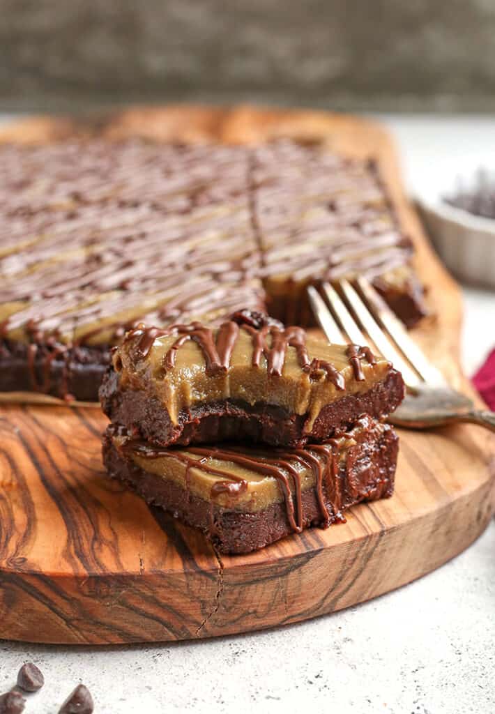 stack of two paleo buckeye brownies with more in the background 