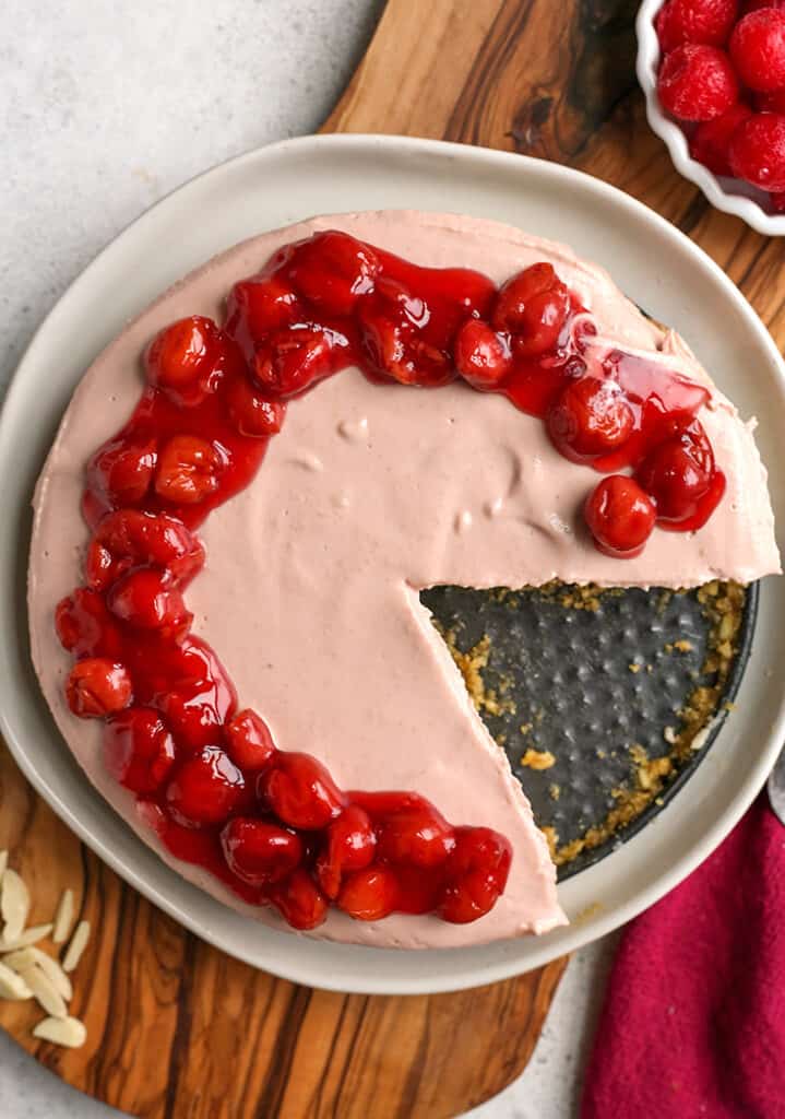 top shot of paleo vegan cherry cheesecake. One slice missing. 