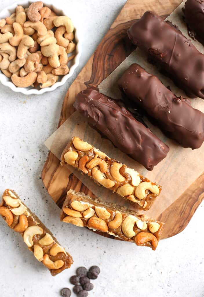 paleo vegan snickers bars on a wooden plate